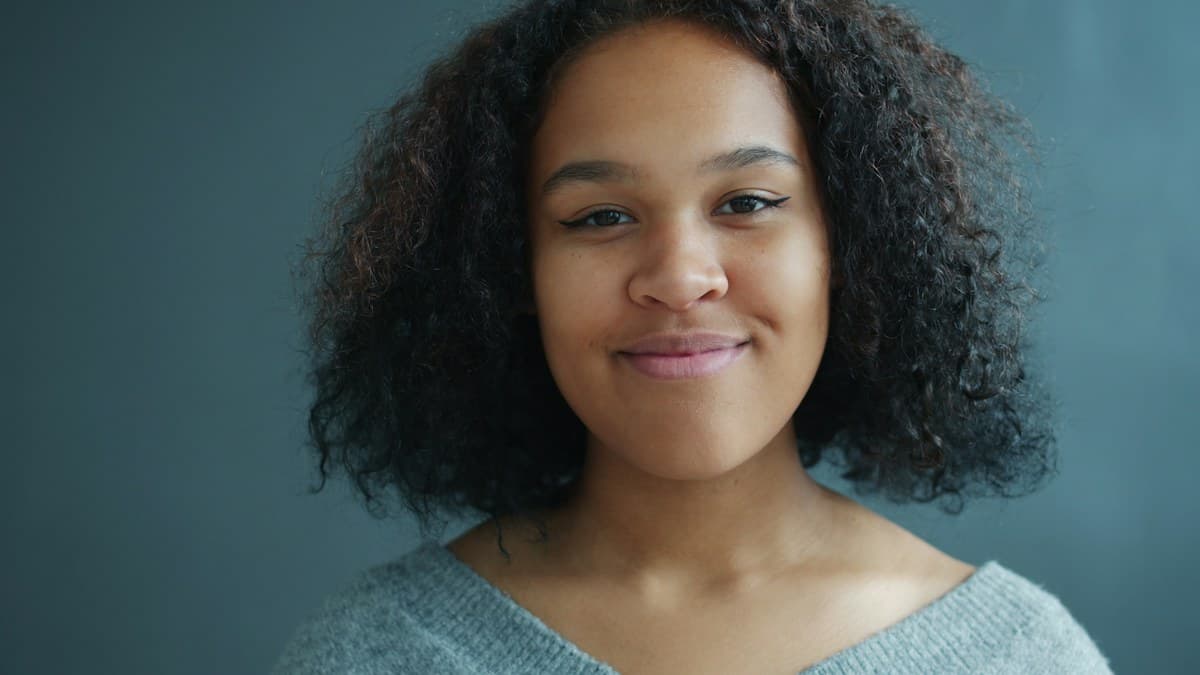 Woman with natural curly hair smiling